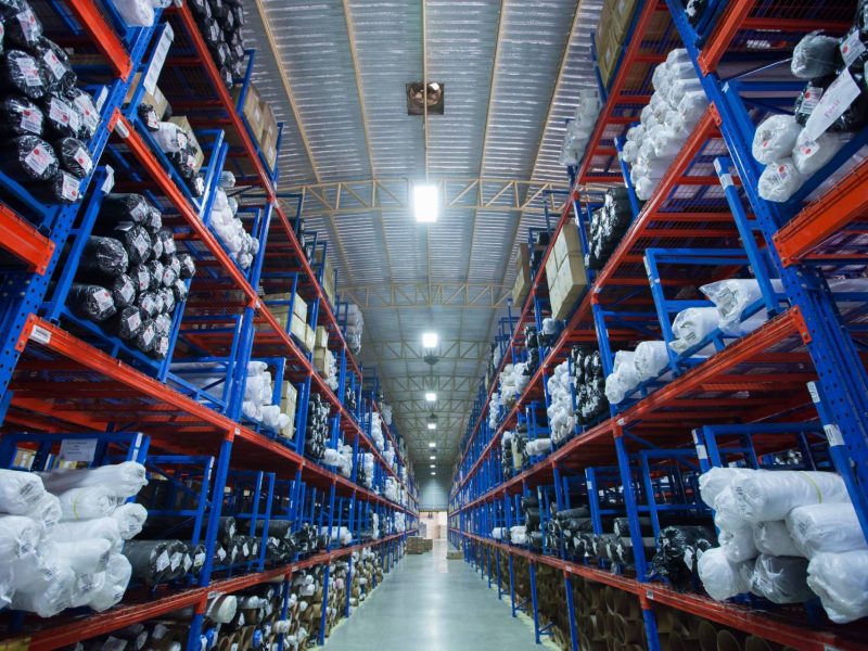 Rows of shelves with boxes in modern warehouse